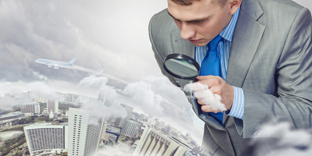 Image of businessman examining objects with magnifier.jpeg