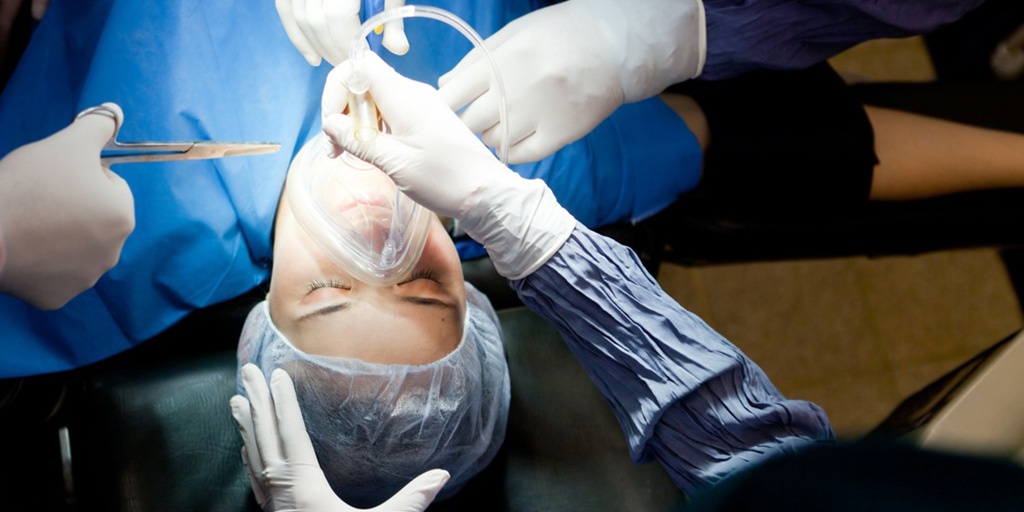 Woman in surgery breathing through an oxygen mask.jpeg